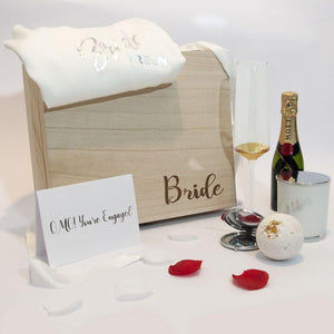 timber gift box filled with wine flute custom card bath fizzer candle gown
