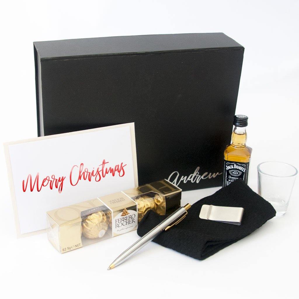 Black gift box, shot glass, alcohol, stainless steel money clip, stainless steel two toned pen, black bamboo socks, ferrero Rocher chocolates, personalised greeting card